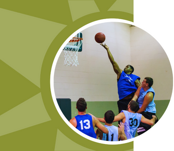 Men in blue jerseys play basketball