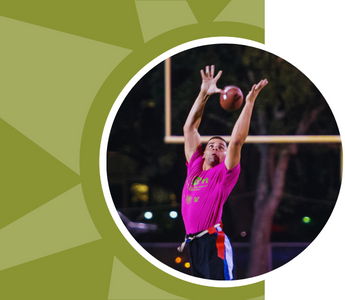 A man leaps to catch a football.