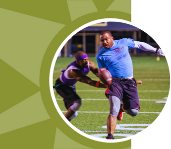 A man avoids a tackle while playing flag football.