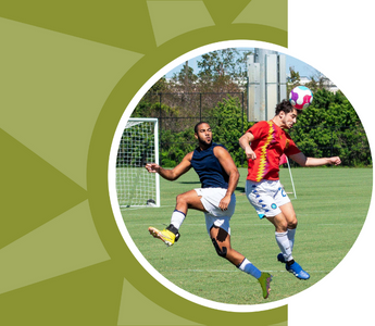 Two men compete for the ball while playing soccer.