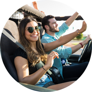 Young couple rides in a car on a sunny day